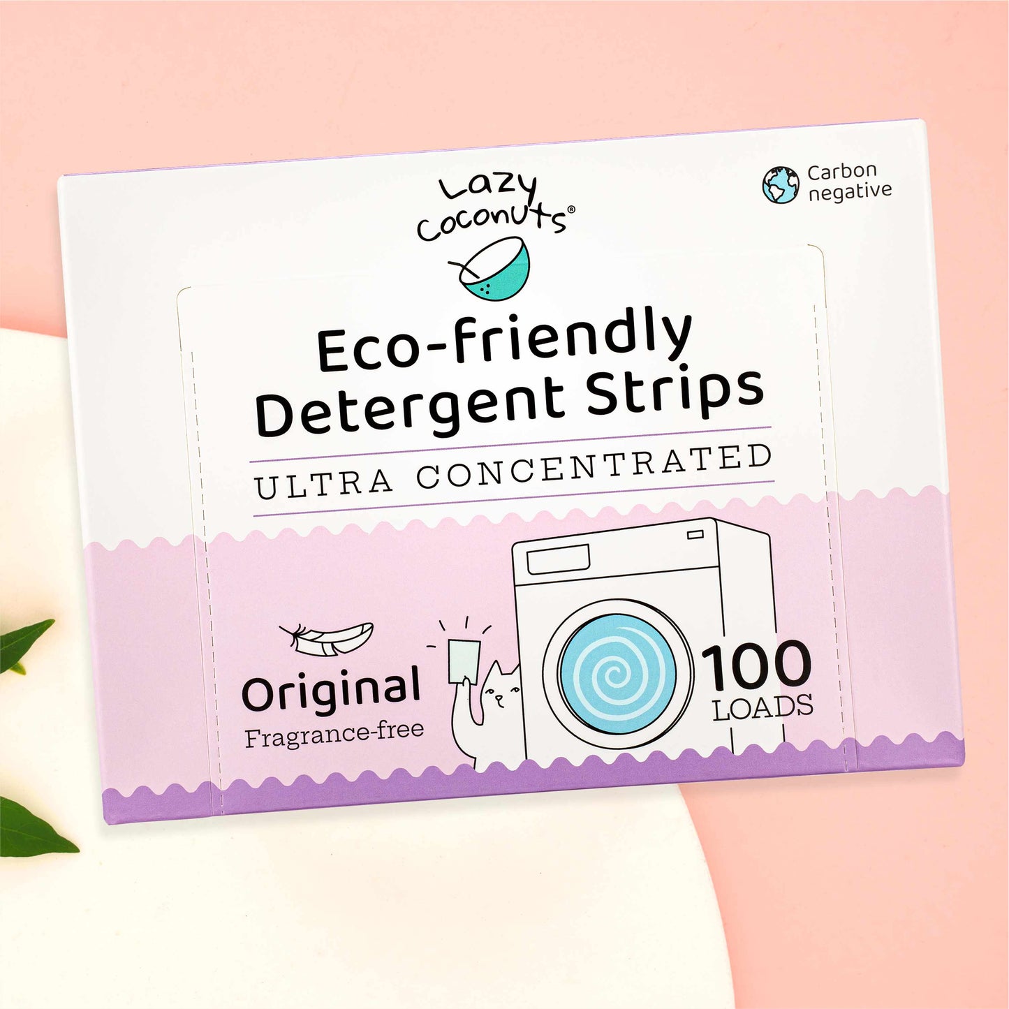 Lazy Coconuts Eco-Friendly Detergent Strips 100 Loads packaging box, featuring a white and pastel pink design with illustrations of a coconut and a washing machine, set against a soft pink background.