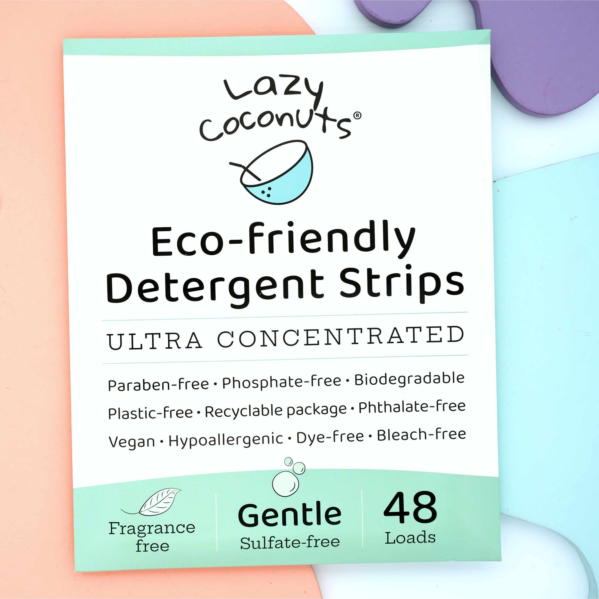 Lazy Coconuts Gentle Eco-friendly Detergent Strips packaging, showing a white and mint green box with text details and a 48 count, styled on pastel-colored background blocks.
